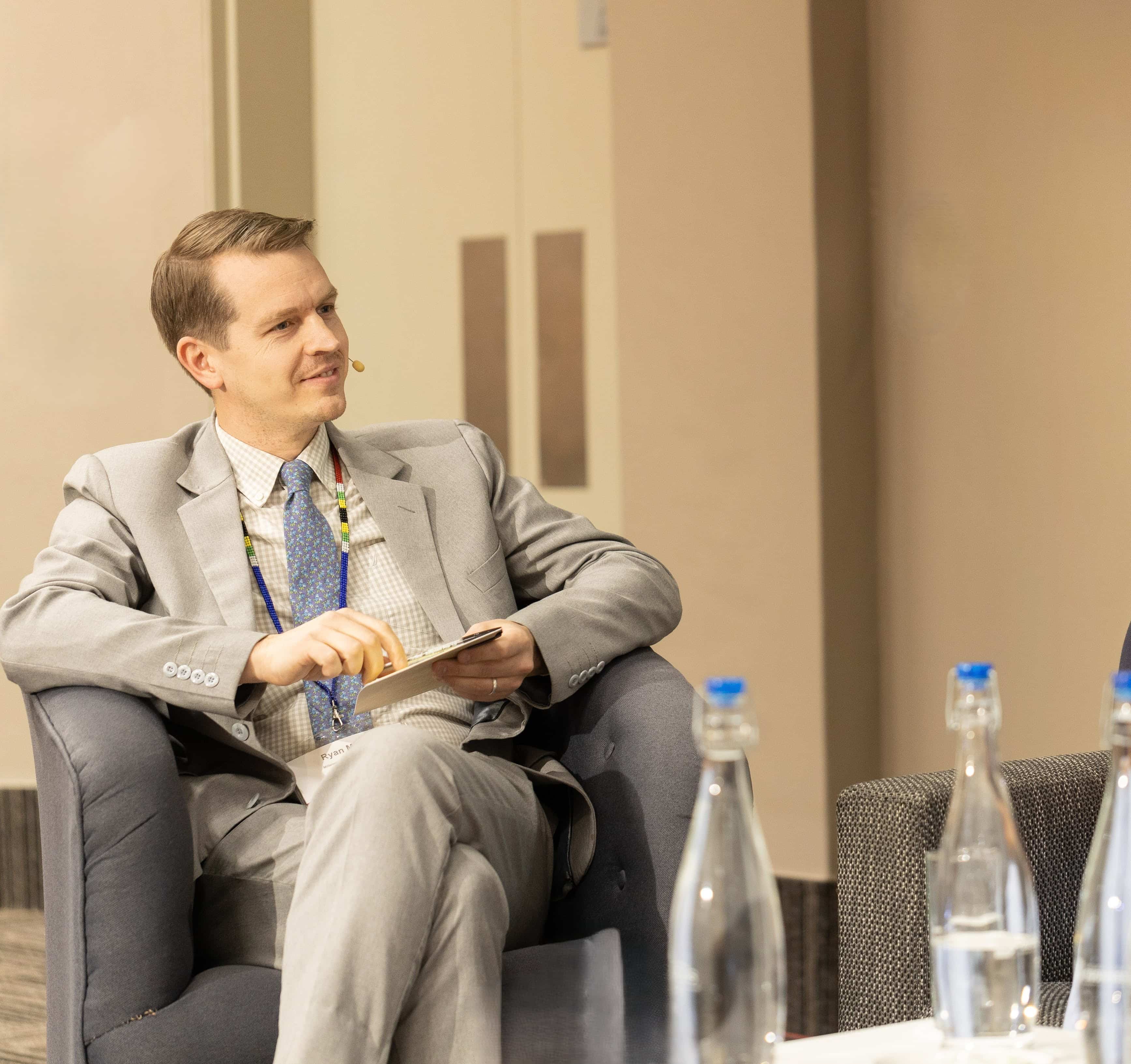 Ryan A. Moore speaking on a panel about international development